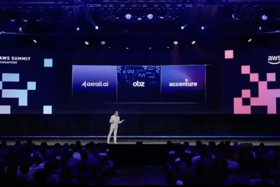 The AWS Summit Singapore keynote stage with axrail.ai on screen
